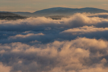 Panorama of mountain peaks above inversion with sunrise and morning frost in Beskydy mountains in...