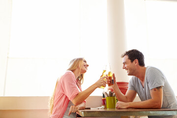 Cheers, couple and date in cafe with beer, smile and romantic bonding together at table for drinks....