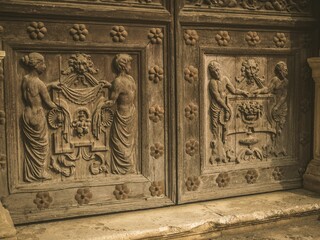 Intricate wooden door carvings with classical figures.