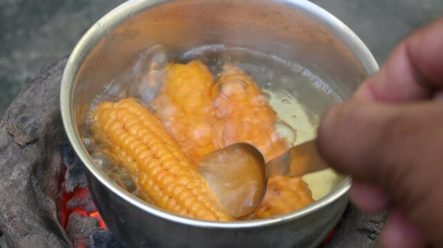 Sweet corn is being boiled. This is a complete food for humans. It contains many vitamins, such as Vitamin B1, B5, C, B9, E, A. Boiled corn on the cob. It's like all over world. Heathy eating. 