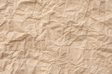 Background or Wallpaper of crumpled brown paper texture that looks like it has been used before. ideal for crafts needing an organic and textured feel that require a classic, retro or vintage.