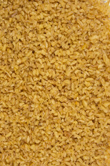 Background of scattered bulgur macro view from above