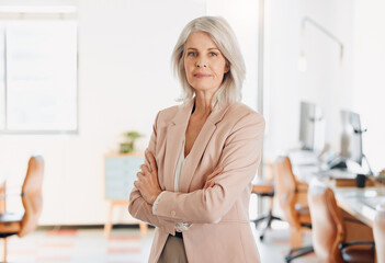 Corporate, crossed arms and portrait of mature woman in office with confidence, company pride and development. Professional, business manager and person in workplace for career, job and ambition