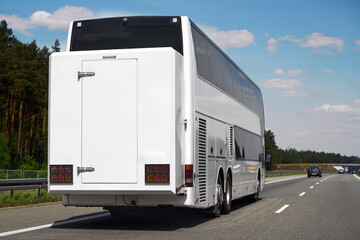 Large double-decker bus driving away