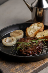 Grilled beef steak with rosemary and toasted baguette