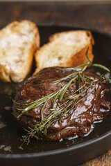Grilled beef steak with rosemary and toasted baguette