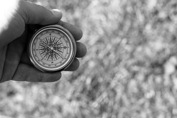 round compass in hand on abstract background