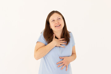 Portrait of extremely happy girl in blue t-shirt holding her stomach and chest and laughing out loud, chuckling giggling at amusing anecdote, sincere emotion. isolated on white background