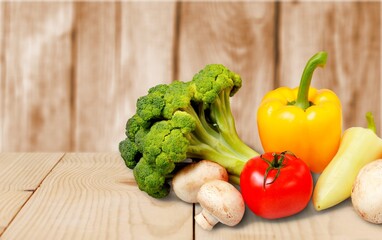 Fresh ripe vegetables and fruits on wooden desk