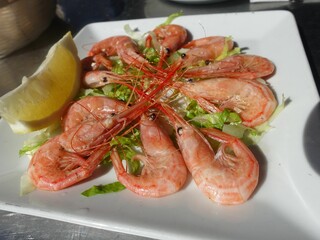 Fresh shrimp plate with lemon and lettuce garnish.