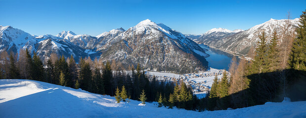 panoramic view from Zwolferkopf mountain to lake achensee and tirolean alps in winter,