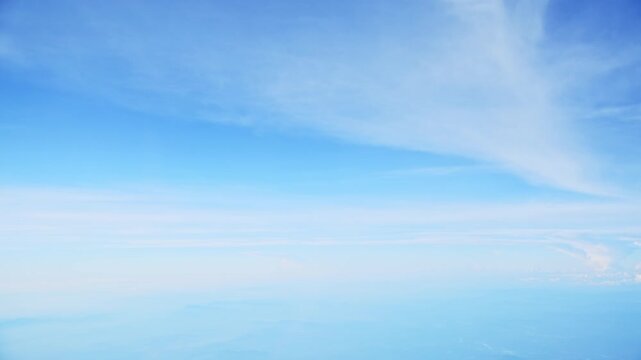 Aerial view of white clouds, from airplane window with blue sky