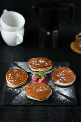 delicious pancakes with berries on a dark background. morning. breakfast