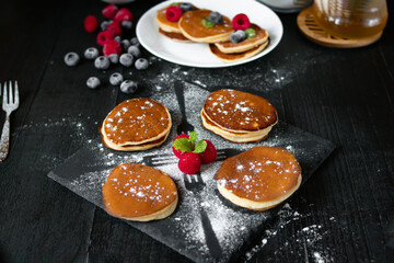 delicious pancakes with berries on a dark background. morning. breakfast