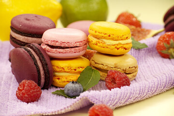 Stack of macaroons next to assortment of fruits