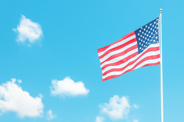 Obraz premium American flag against blue sky, US presidential election, american national holiday, July 4, Veterans or memorial day