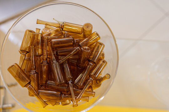 Empty medicine bottles in bowl at pharmacy