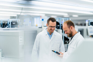 Electrical technicians in electronics factory having work meeting