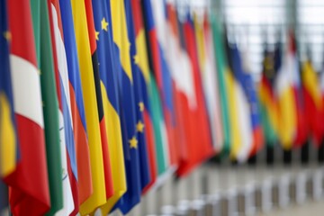 Fototapeta premium Flags from various European Union member states billow in the Council building, symbolizing unity and collaboration during an important summit in Brussels.