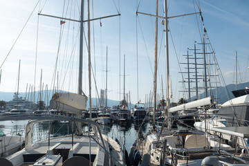 Scenic Yacht Marina with Sailboats and Masts in the Sunlight - Serene Harbor View of Sailboats Docked in a Busy Marina. High quality photo