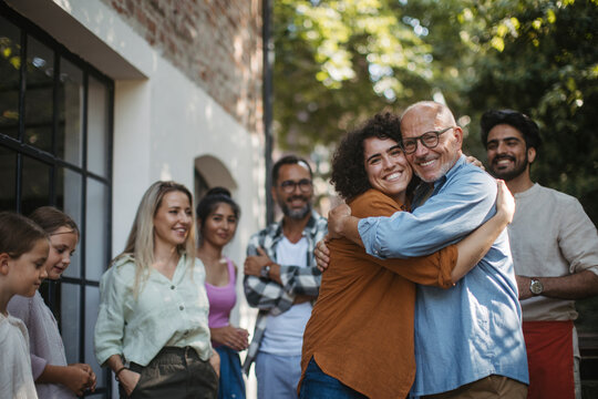 Diverse group of community members embracing successful community project