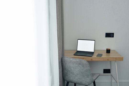 Wooden table with wireless laptop on it at home office