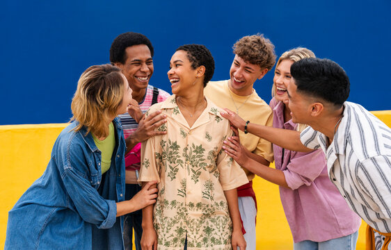 Group of friends are happy for young woman and encouraging her