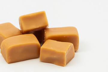 White with a toffee and candy. sweet dessert food concept. a white with a toffee and milk on it. a white with brown and white candies lifestyle and candy.