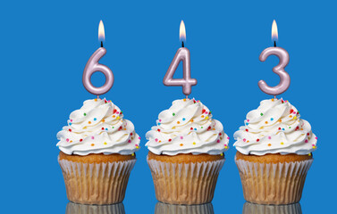 Birthday Cupcakes With Candles Lit Forming The Number 643