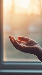 Hand reaching out, soft sunlight in background, conveying warmth and openness.
