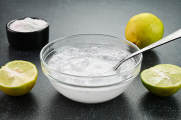 Mixing baking soda with water and lemon.