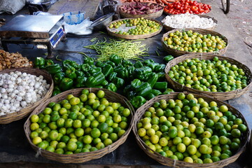 Variety of fresh vegetables are ready for sell in the market like capsicum, green tomatoes, red tomatoes, lemons, garlics, peas and many others 