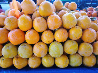 Delicious persimmons on display at the market stall.