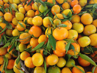 Delicious orange-colored tangerines on display at a greengrocer's stall.