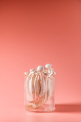 shimeji mushrooms in glass, on pink, peach fuzz background