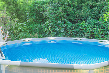 Swimming pool with clear water in the garden in summer.