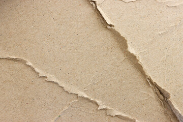 cardboard sheet textured background with crumples and torn, brown color