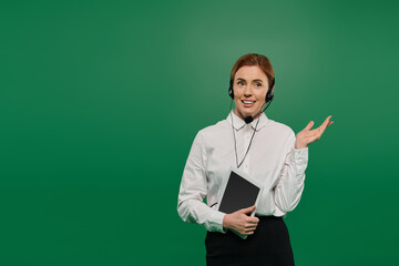 A professional woman dressed in a white shirt communicates enthusiastically in a call center...