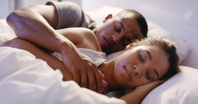 Couple, hug and sleeping in bed at house for relax, love and fatigue together with rest, break and night. Man, woman and cuddle in home bedroom for comfort, exhausted or tired on weekend with pillow - Powered by Adobe