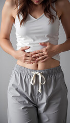 Woman holding stomach in discomfort with abdominal pain