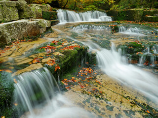 Waterfall in the autumn landscape in the mountains
