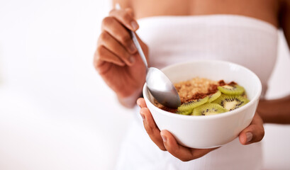 Woman, hands and bowl with fruit for diet, healthy meal or snack in studio on a white background. Closeup, female person or model with kiwi, oats or natural organic food for breakfast or nutrition