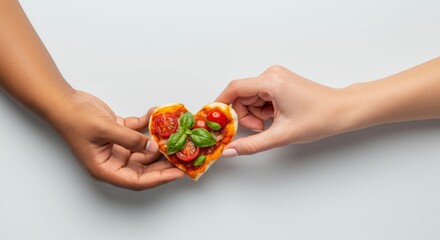 Heart-shaped mini pizza with cherry tomatoes and basil held by diverse hands. Valentine’s Day scene