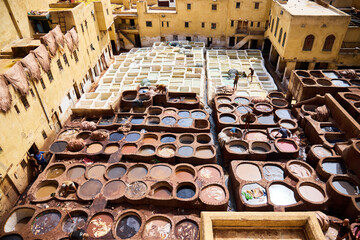 People works in the Shuara leather dyeing factory. Traditional Moroccan craft.