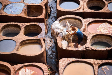 People works in the Shuara leather dyeing factory. Traditional Moroccan craft.