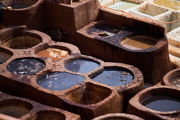 People works in the Shuara leather dyeing factory. Traditional Moroccan craft.