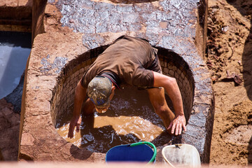 People works in the Shuara leather dyeing factory. Traditional Moroccan craft.