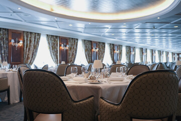 Formal and elegant ocean view dining room restaurant onboard luxury cruiseship or cruise ship liner...