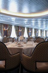 Formal and elegant ocean view dining room restaurant onboard luxury cruiseship or cruise ship liner...