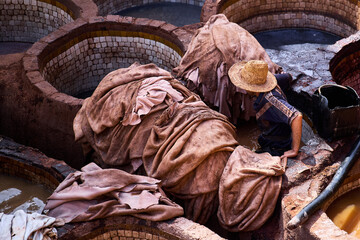 People works in the Shuara leather dyeing factory. Traditional Moroccan craft.